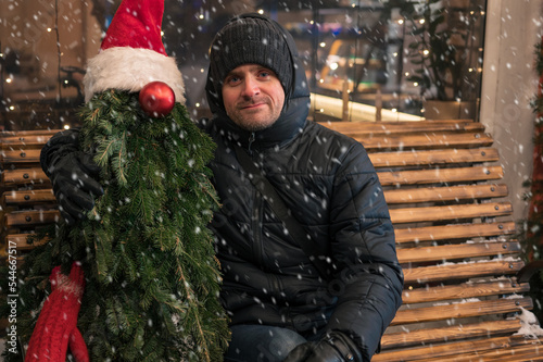 Man with fir tree decorated...