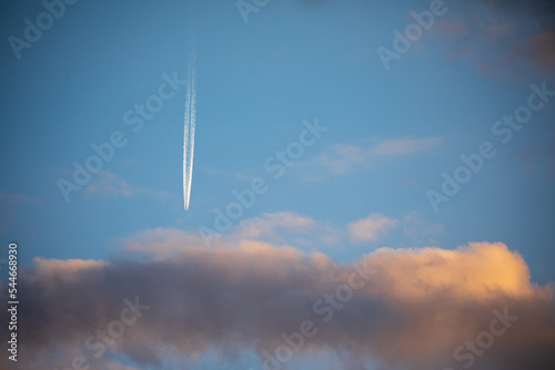 plane jet chem trail against blue sky photo