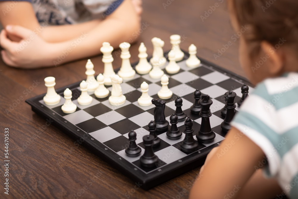 Teenager boy and little girl play chess Teenager boy and little girl play chess