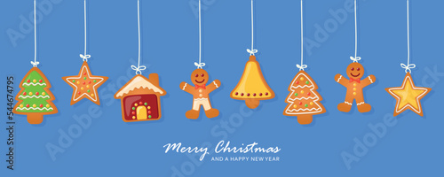 christmas card with hanging gingerbread cookies decoration on blue background