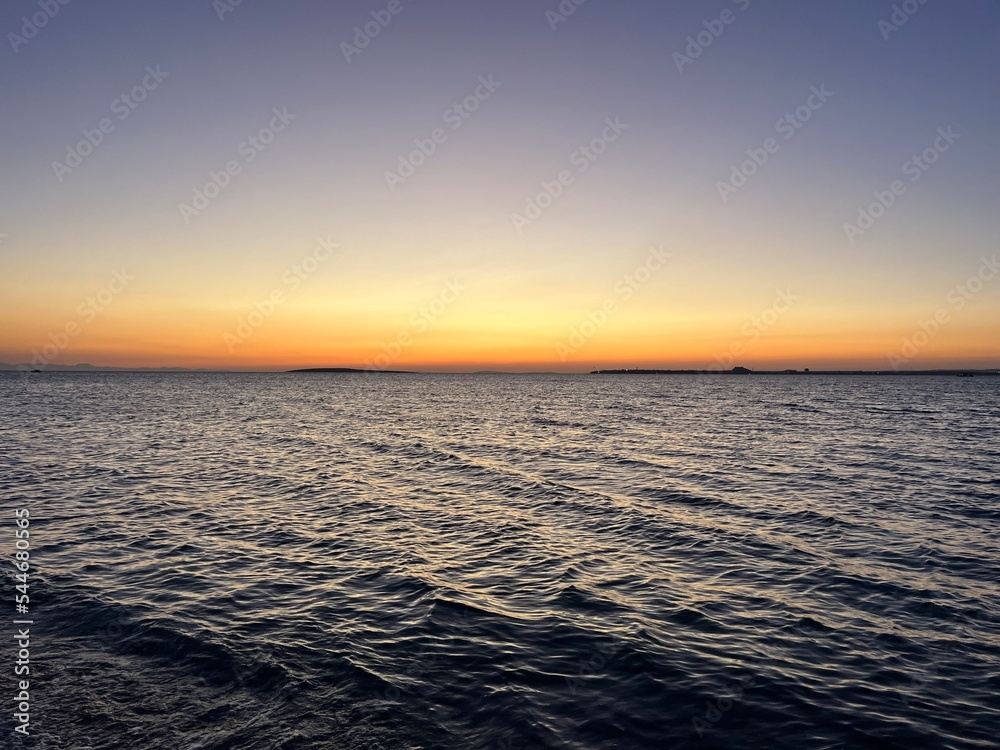 Orange sea sunset, evening quiet sea horizon 