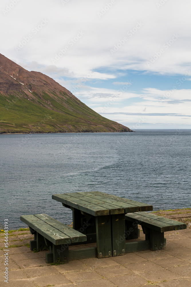 a green bench at the bay of Ólafsfjörður