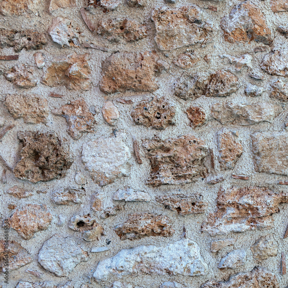 old stone wall made of sandstone blocks of different sizes as the background old stone wall made of sandstone blocks of different sizes as the background