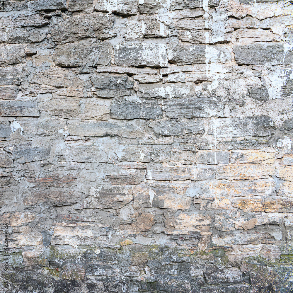 old brick wall made of sandstone blocks of different sizes as a background old brick wall made of sandstone blocks of different sizes as a background