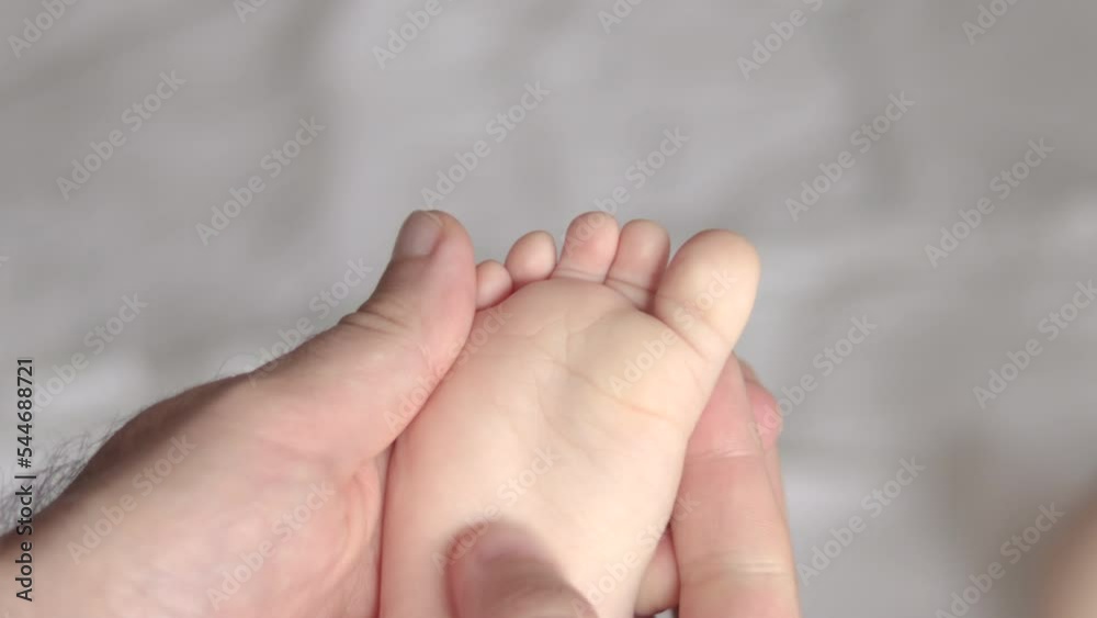 daddy father hands massaging cute little baby infant new born feet with fingers.close up dad care baby toddler is irritated moving legs refuse to stay chill nervous upset.little toes barefoot kid 4k daddy father hands massaging cute little baby infant new born feet with fingers.close up dad care baby toddler is irritated moving legs refuse to stay chill nervous upset.little toes barefoot kid 4k