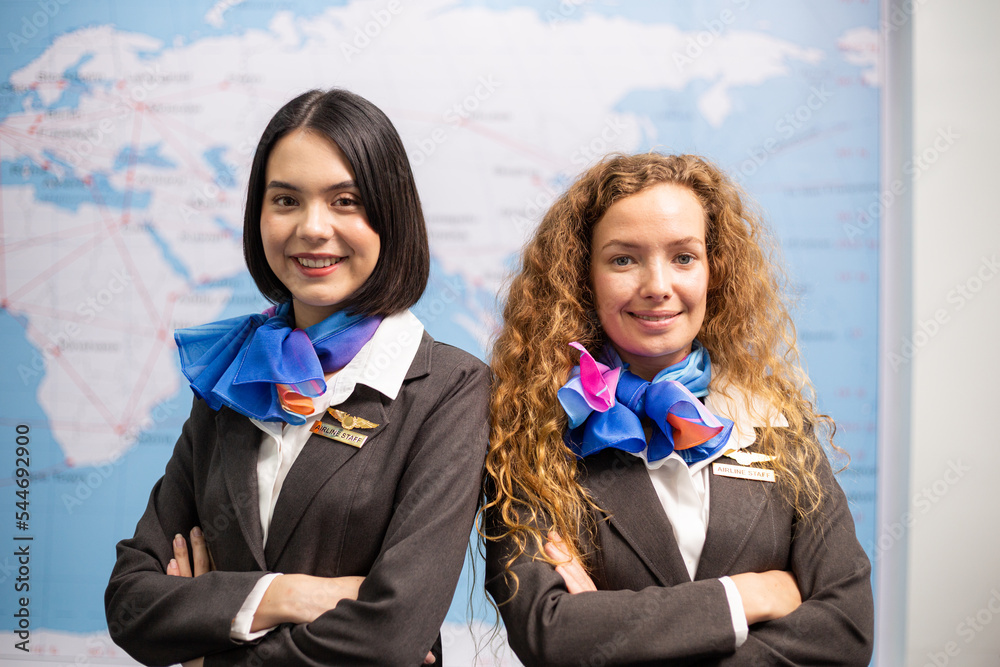 Portrait of female airline officer looking smile at camera at airport office. travel service mind concept Portrait of female airline officer looking smile at camera at airport office. travel service mind concept
