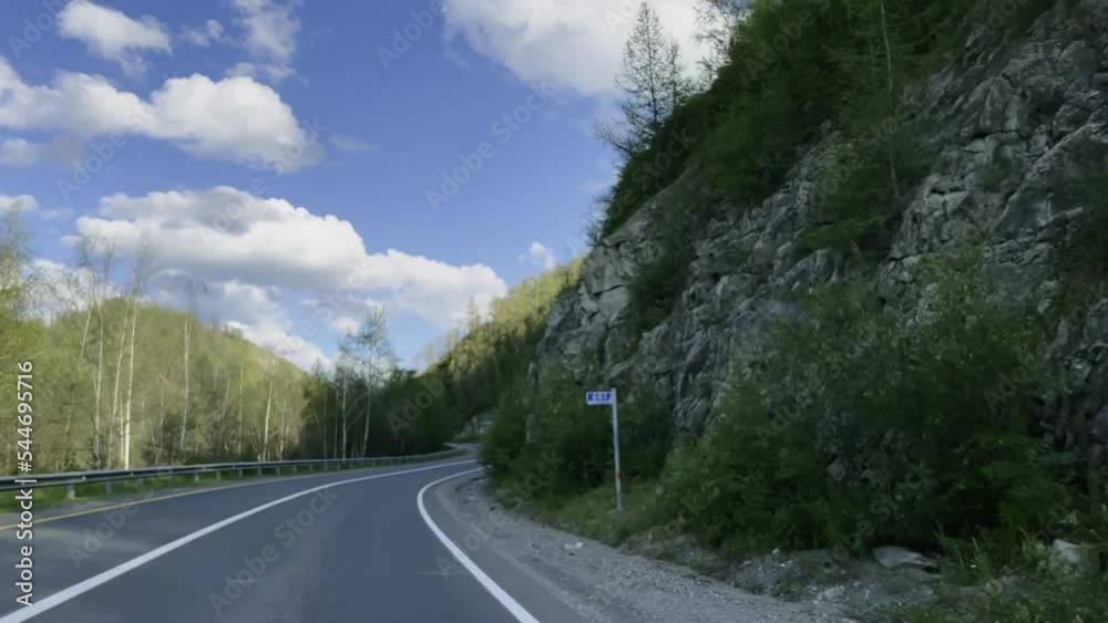 The car is moving along a mountain serpentine among green mountains. High quality 4k footage The car is moving along a mountain serpentine among green mountains. High quality 4k footage