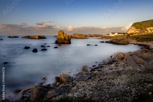 Long exposure of a rocky seascape scene. Soft waves breaking on the rocks. Game of Thrones location, Ballintoy Harbor, Co. Antrim, Northern Ireland.