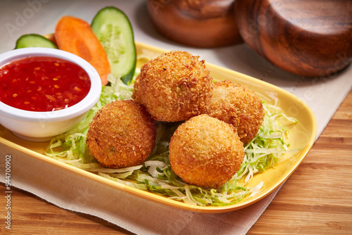 Fried Cheese Balls with chili sauce and salad served in dish isolated on table side view of middle east food