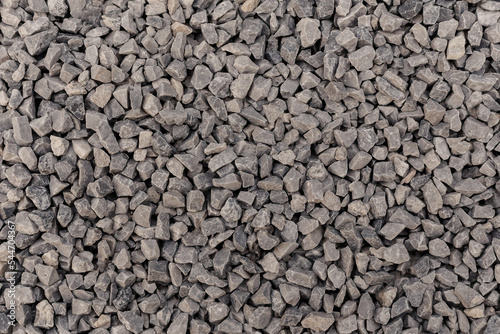 Crushed stone close up. Crushed stone construction materials. Small stones ground. Small stone construction material. Background, texture of stones. 
