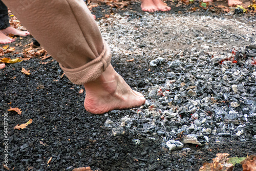 People walk on hot coals barefoot. photo