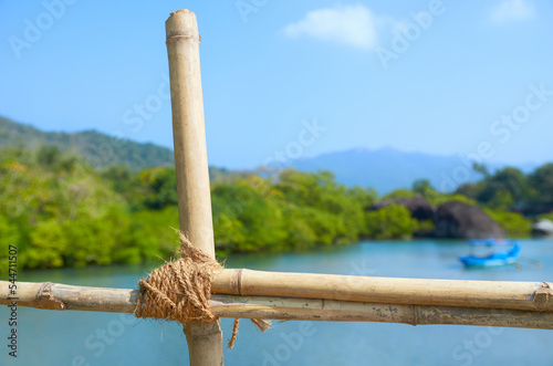 Knot fastening bamboo sticks close-up. Bamboo fence on the bridge.