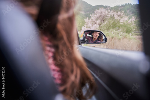 pretty girl reflected in the car mirror