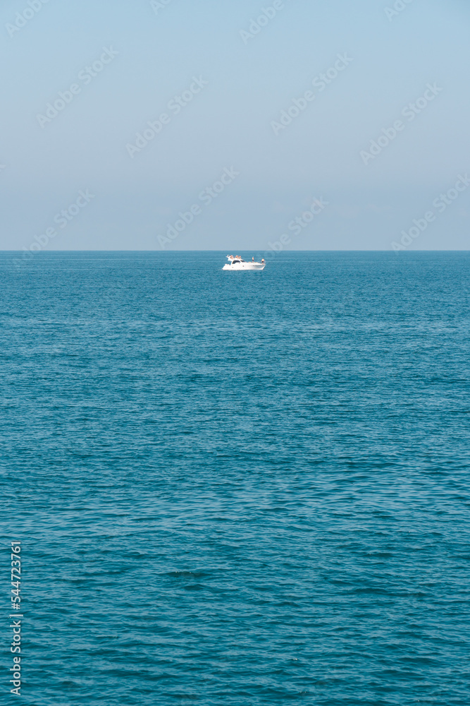 White boat on the horizon of the sea, Batumi