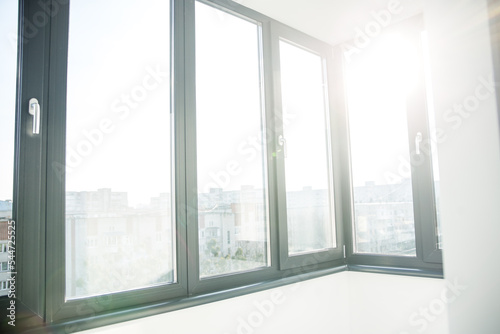 Foto Balcony with black window in flat. Sunlight.