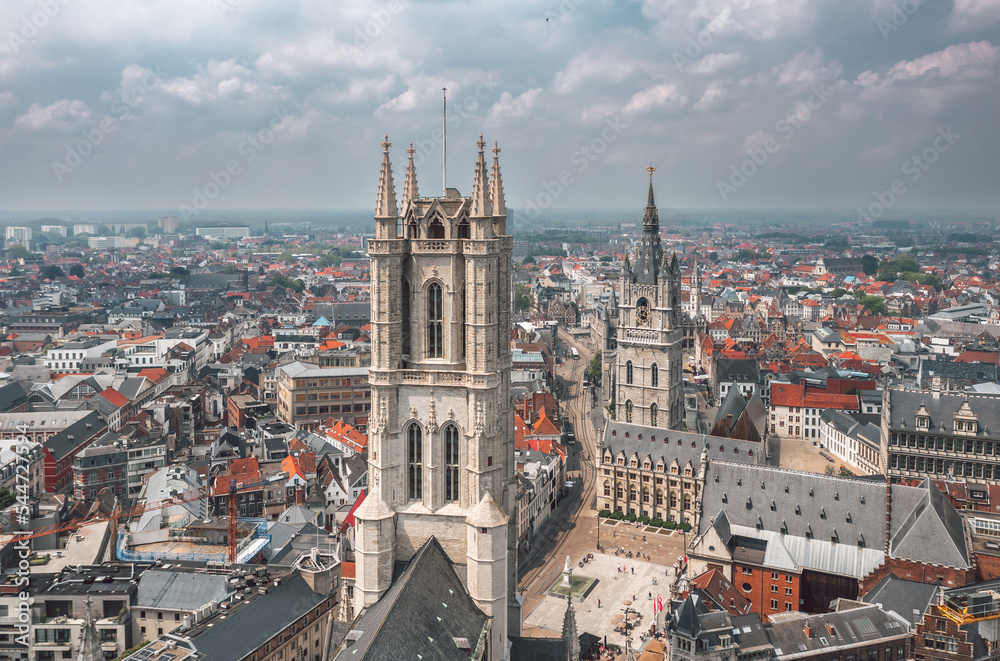 Aerial summer cityscape of the Old Town in Ghent (Gent), Belgium. Sint-Baafskathedraal cathedral and Het Belfort van Gent tower in the foreground