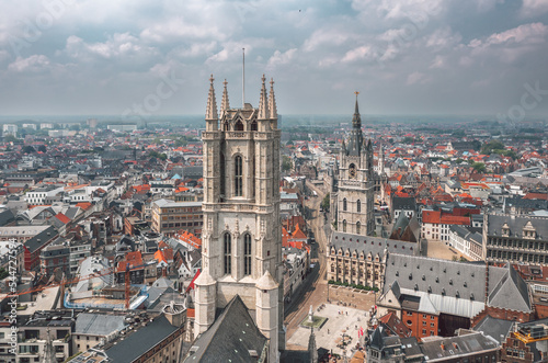Aerial summer cityscape of the Old Town in Ghent (Gent), Belgium. Sint-Baafskathedraal cathedral and Het Belfort van Gent tower in the foreground