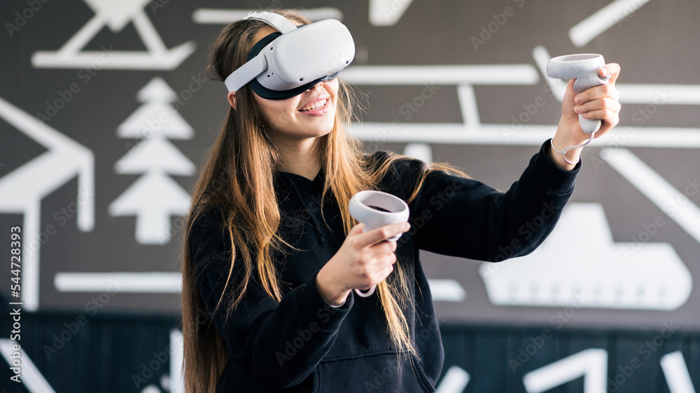 A young woman playing in VR glasses