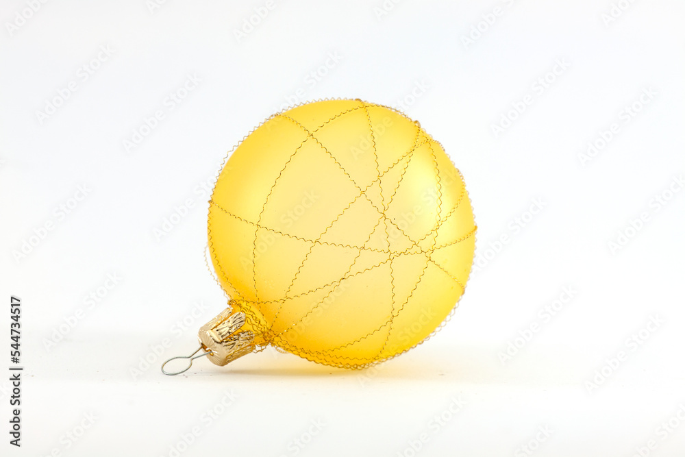 Christmas ball yellow New Years Eve bauble decoration shiny wintertime hanging sphere adornment souvenir. Traditional ornament happy winter holidays Merry Xmas symbol golden. 