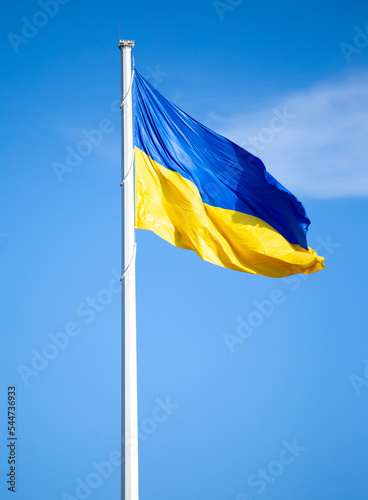 National flag of Ukraine against blue sky