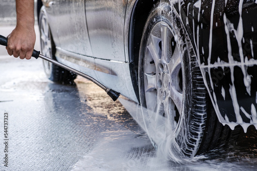 Car wash. Close-up car is in the active foam.