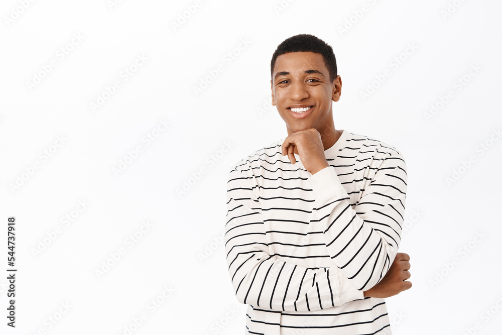 Portrait of african american man thinking, looking thoughtful, checking out smth interesting, standing over white background Portrait of african american man thinking, looking thoughtful, checking out smth interesting, standing over white background