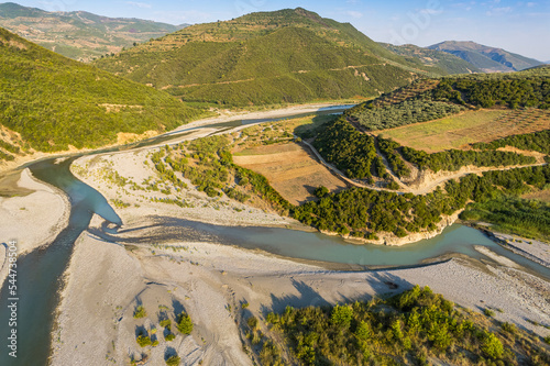Fototapeta Naklejka Na Ścianę i Meble -  Aerial view of river Osumi by village Mbrakull near Polican in Albania in Summer sunrise