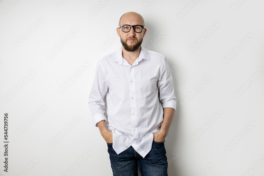 Young man in a white shirt stands on a white background Young man in a white shirt stands on a white background