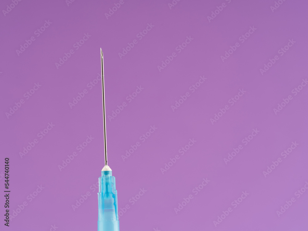 A macro shot of a medical syringe with a needle. Space for text A macro shot of a medical syringe with a needle. Space for text
