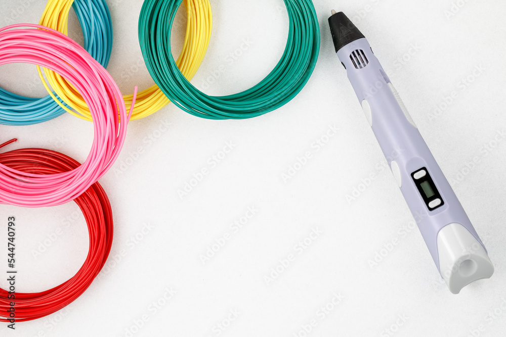 Top view on 3d pen, kit of colourful PLA or ABS plastic filament on white background. Close-up - obrazy, fototapety, plakaty 
