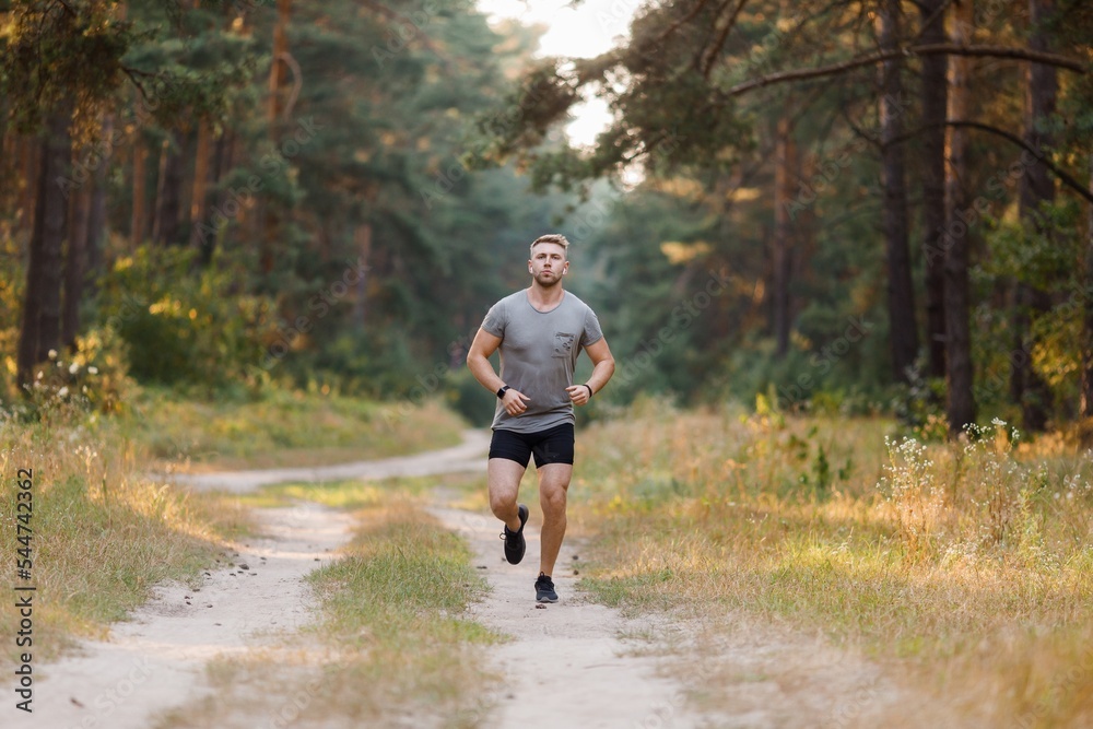 Muscular man running outdoors
