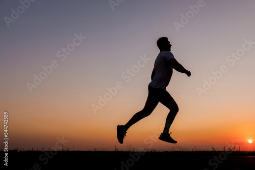 Active man running during sunset