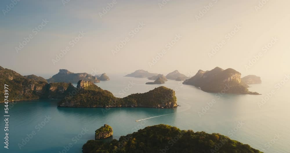 Aerial summer sun light ocean island landscape. Blue sea water and tropical green mountain. Cloudless sunset bright sky. Seychelles paradise beach. Speed boat tropical trip concept. Vacation tourism. Aerial summer sun light ocean island landscape. Blue sea water and tropical green mountain. Cloudless sunset bright sky. Seychelles paradise beach. Speed boat tropical trip concept. Vacation tourism.