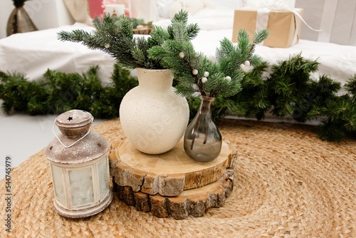 Minimalistic Christmas composition with fir branches in a modern ceramic vase. Front view. Copy space