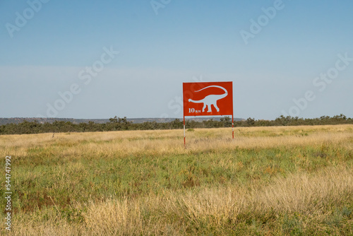 Cut out metal sign showing how far to a dinosaur attaction in Winton, Queensland,Australia. photo