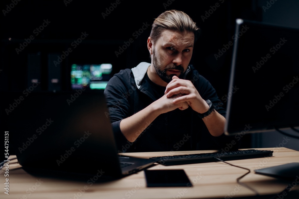 Skillful hacker working on computers Skillful hacker working on computers