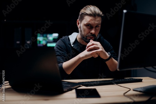 Skillful hacker working on computers