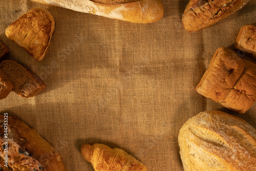 Freshly baked traditional bread on burlap. Healthy food, traditional craft bread concept.