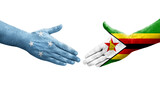 Handshake between Micronesia and Zimbabwe flags painted on hands, isolated transparent image.