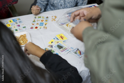 People playing board games, loteria with friends