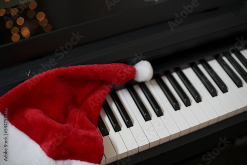 Santa claus hat over piano