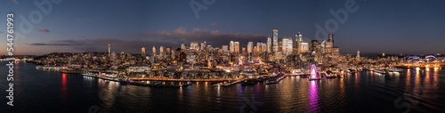 Seattle, Washington, USA - November 2022, night aerial view of illuminated Seattle Downtown and the Waterfront pier area with The Seattle Great Wheel - aerial panoramic view 