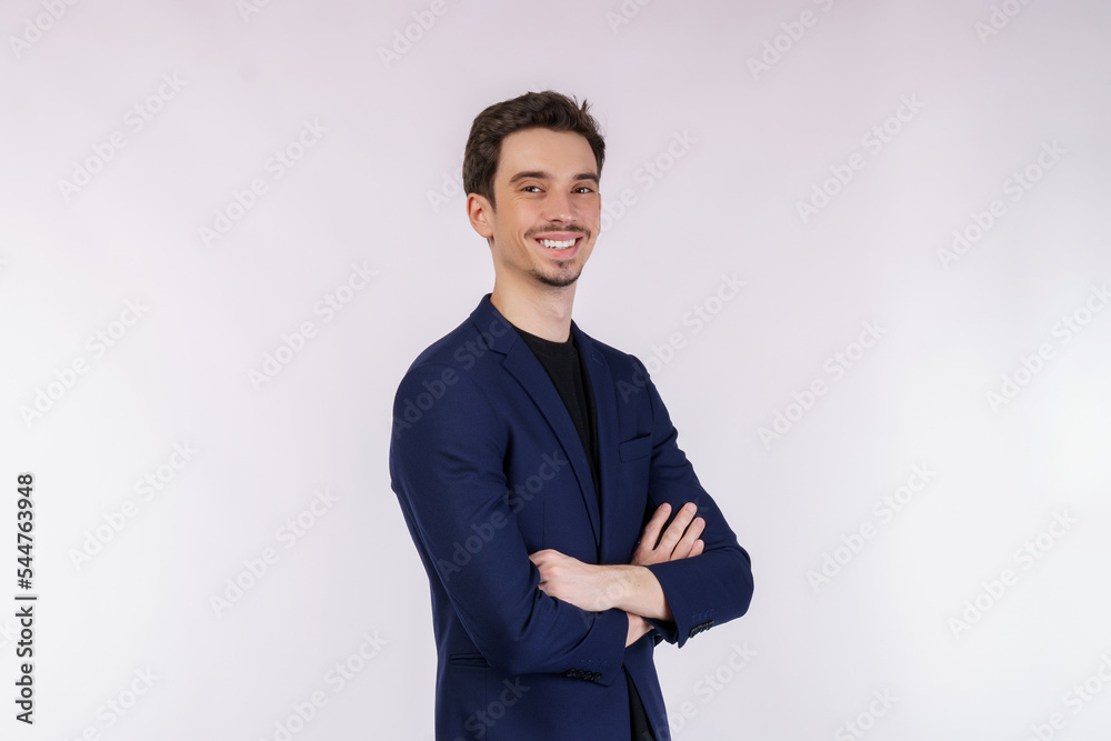 Portrait of young handsome businessman wearing suit standing with crossed arms with isolated on studio white background Portrait of young handsome businessman wearing suit standing with crossed arms with isolated on studio white background