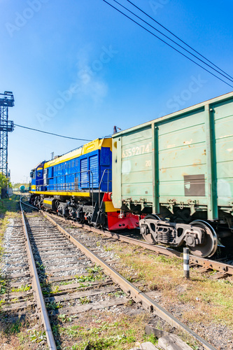 Red-blue Diesel locomotive pulling freight train.