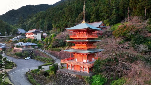 beautiful Japanese pagoda in the mountains with a waterfall, aerial view of Japanese buddhist shrine, famous tourist destination in Japan