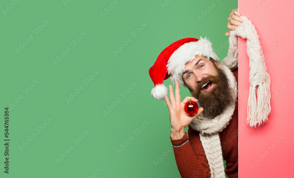 Excited man in Christmas sweater and santa hat. Bearded santa man, christmas card, new year banner with copy space. Happy hipster man in santa hat. Excited man in Christmas sweater and santa hat. Bearded santa man, christmas card, new year banner with copy space. Happy hipster man in santa hat.