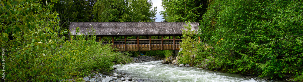 View of Fitzsimmons Creek and a covered wooden bridge over the whitewater river, Whistler, BC, Canada
View of Fitzsimmons Creek and a covered wooden bridge over the whitewater river, Whistler, BC, Canada