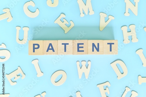 Patent business concept. Word typography on wooden blocks flat lay.