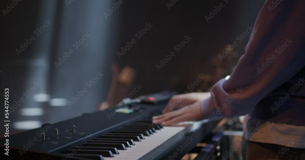 Somebody is performing with a piano on a big Stage Somebody is performing with a piano on a big Stage