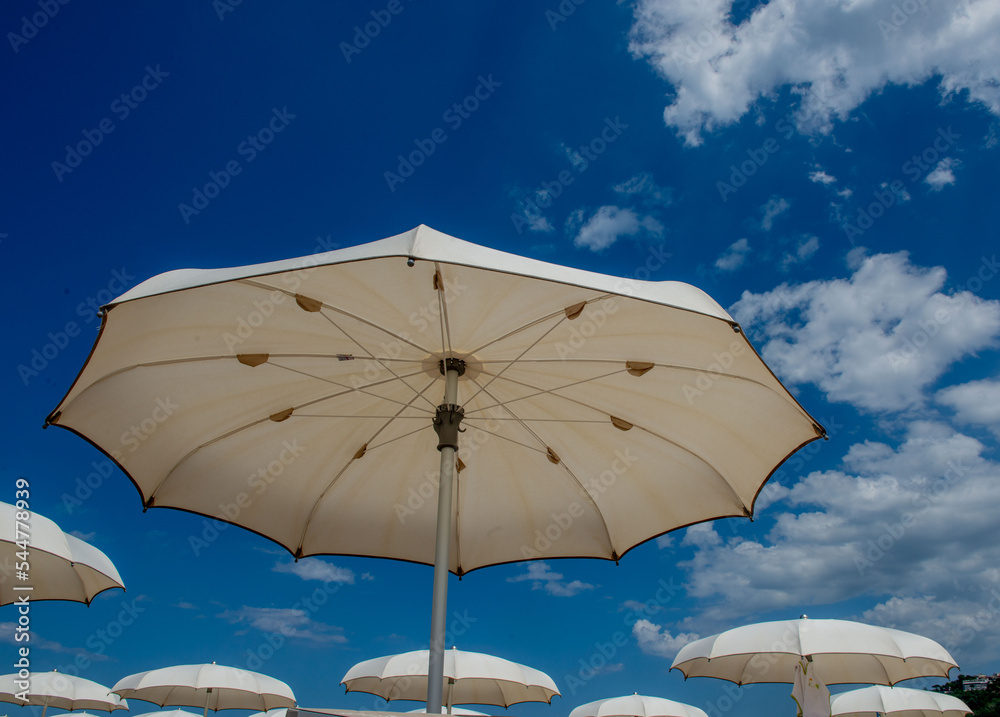 White umbrellas open on the beach